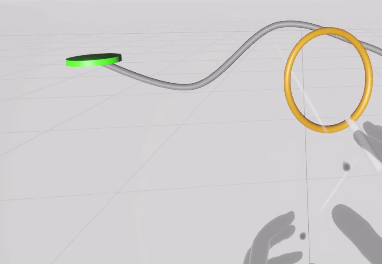 VibeSkin VR buzz-wire game: a gold ring held by a tracked virtual hand slides along a curving wire